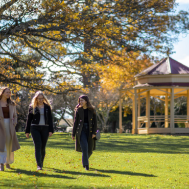 Three girls walking through Ryrie Park, Braidwood